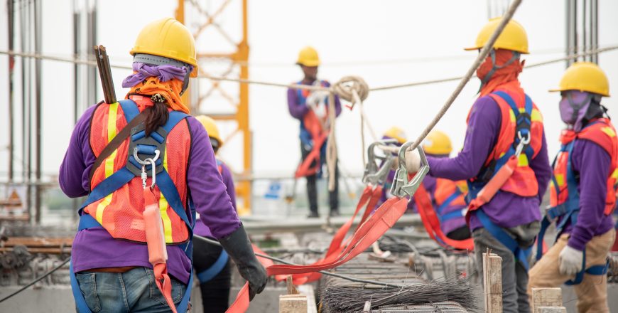 Construction workers working at heights with proper safety protocols. Refresher course for Working At Heights on a construction site.