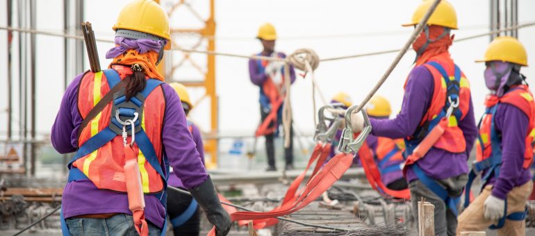 Construction workers working at heights with proper safety protocols. Refresher course for Working At Heights on a construction site.